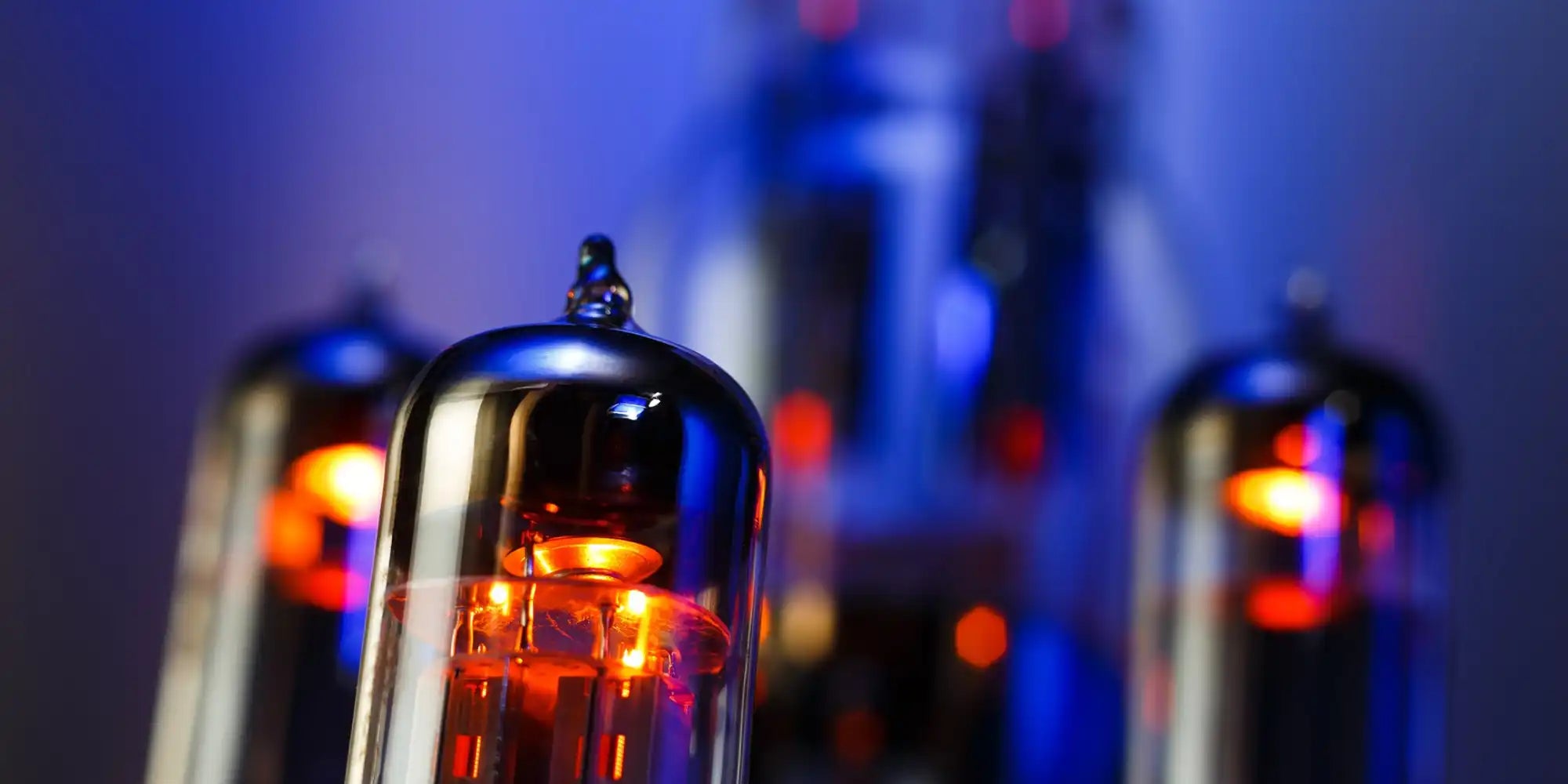 Classic vacuum tube amplifier with glowing red filament and metallic body.